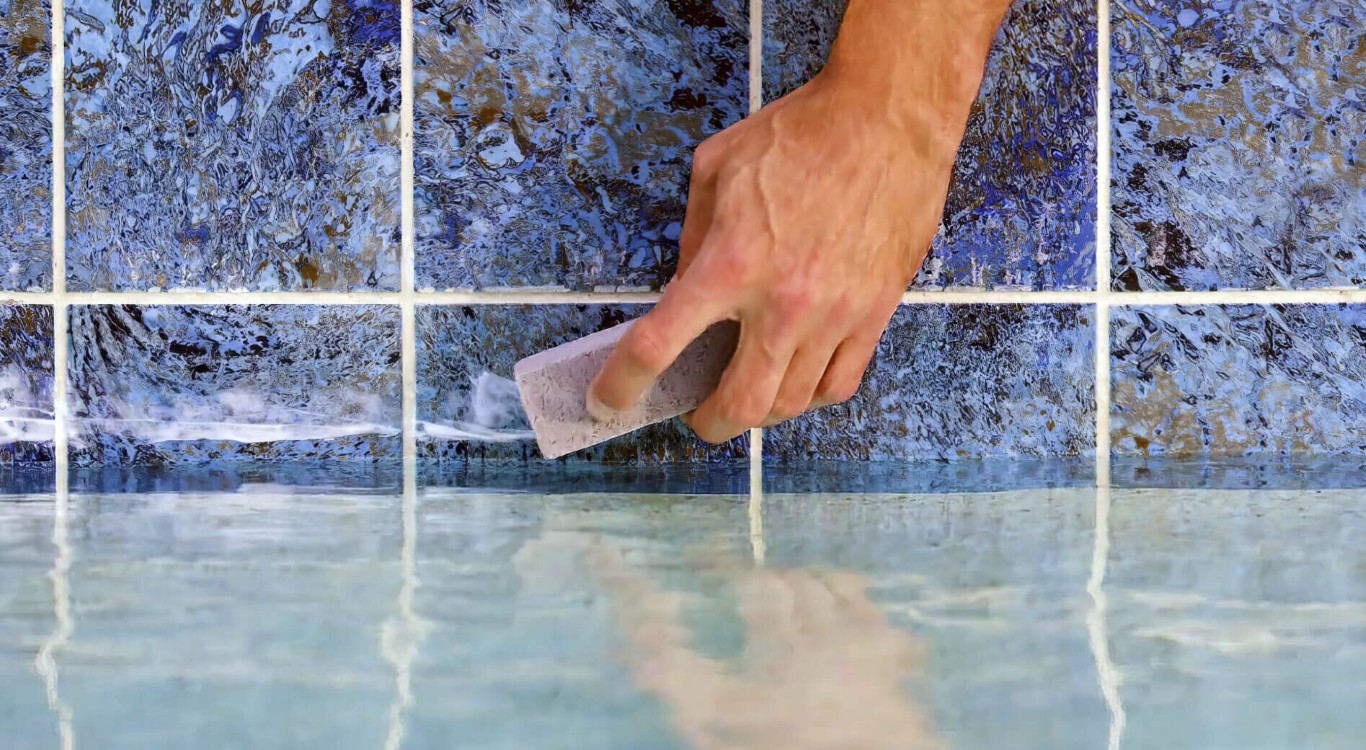 Reliable pool cleaning technicians working on pool tile in Fontana, CA